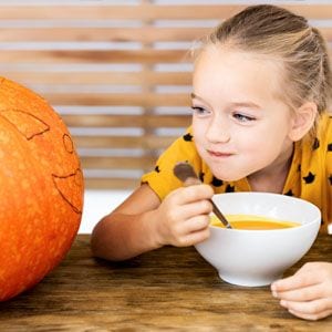 girl eating pumpkin soup